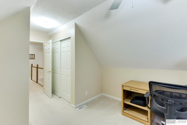 carpeted office featuring baseboards, ceiling fan, a textured ceiling, and visible vents