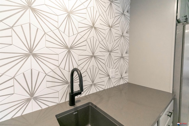 interior details with a sink and freestanding refrigerator