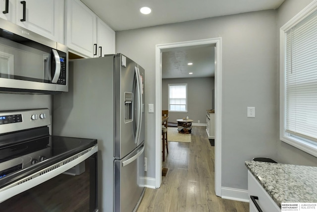 kitchen with stainless steel appliances, baseboards, recessed lighting, white cabinetry, and light wood-type flooring