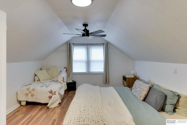 bedroom featuring a ceiling fan, wood finished floors, and lofted ceiling