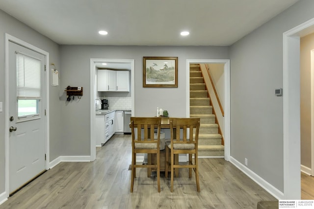 dining area featuring stairway, recessed lighting, baseboards, and light wood finished floors