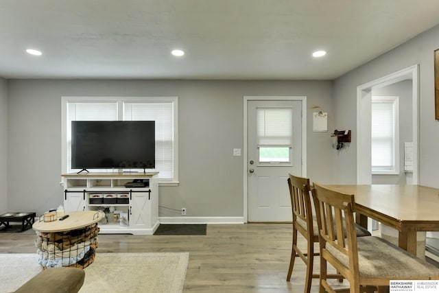 living room with recessed lighting, baseboards, and wood finished floors