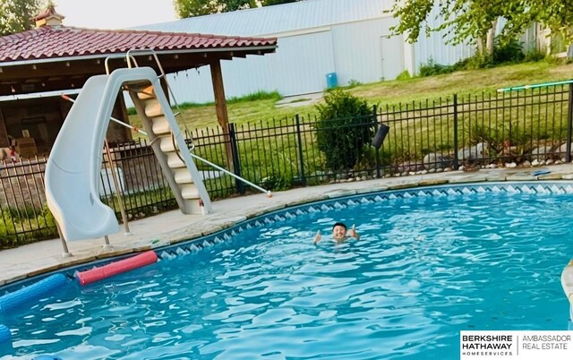 11380 24th Ave, Plattsmouth, NE 68048 - view of swimming pool featuring fence, a water slide, and a fenced in pool