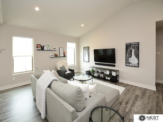 living area featuring visible vents, lofted ceiling, wood finished floors, baseboards, and recessed lighting