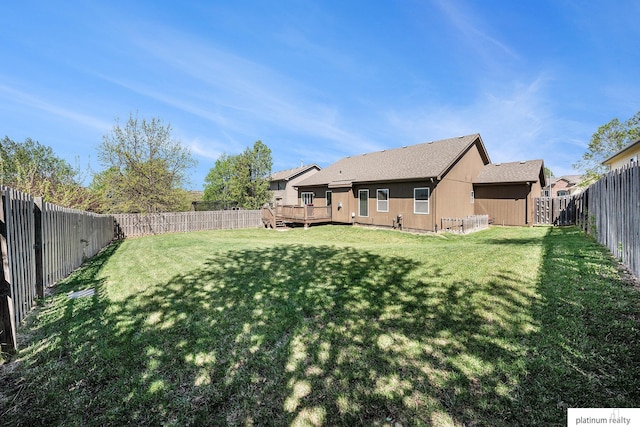 view of yard with a deck and a fenced backyard