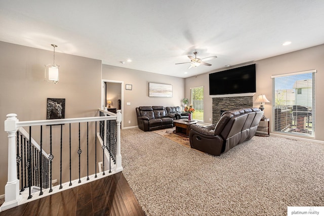 living room featuring a ceiling fan, baseboards, recessed lighting, and a wealth of natural light