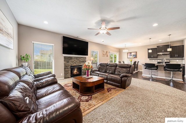 living room with plenty of natural light, a ceiling fan, dark wood-style flooring, and recessed lighting