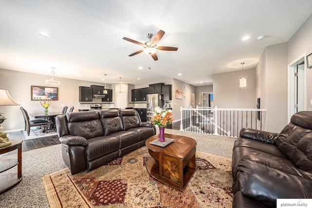 living room featuring a ceiling fan, baseboards, and recessed lighting