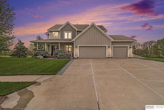 view of front of property with a front lawn, a garage, board and batten siding, covered porch, and driveway