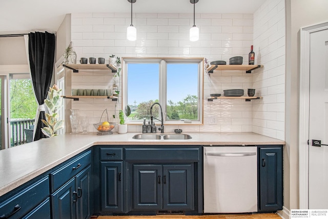kitchen with open shelves, dishwasher, blue cabinets, a sink, and backsplash