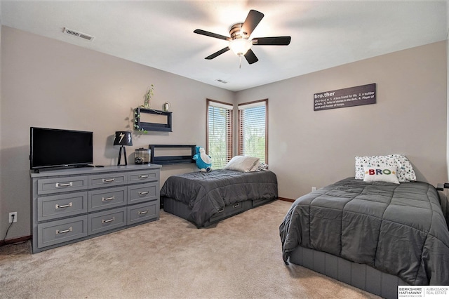 bedroom with visible vents, a ceiling fan, baseboards, and light carpet