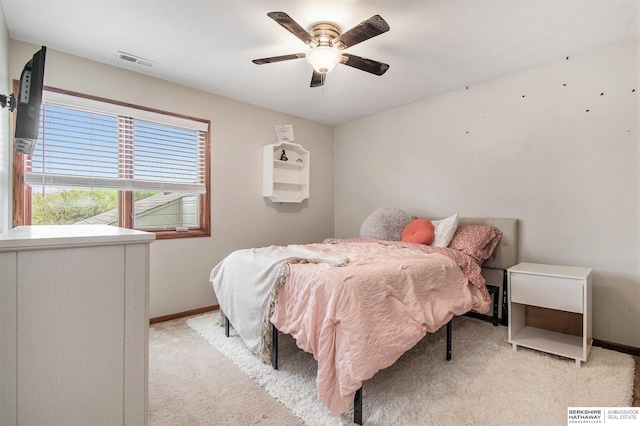 bedroom with baseboards, ceiling fan, light colored carpet, and visible vents