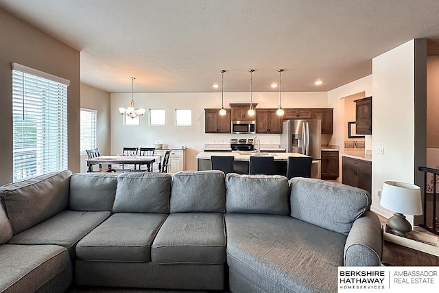 living room with recessed lighting and a notable chandelier