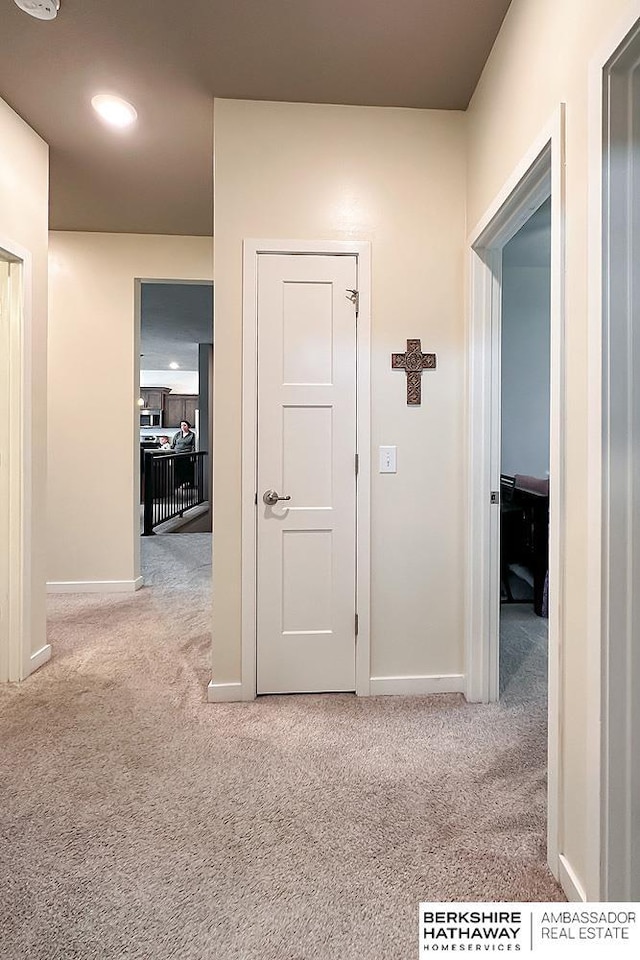 corridor with baseboards, carpet flooring, and recessed lighting