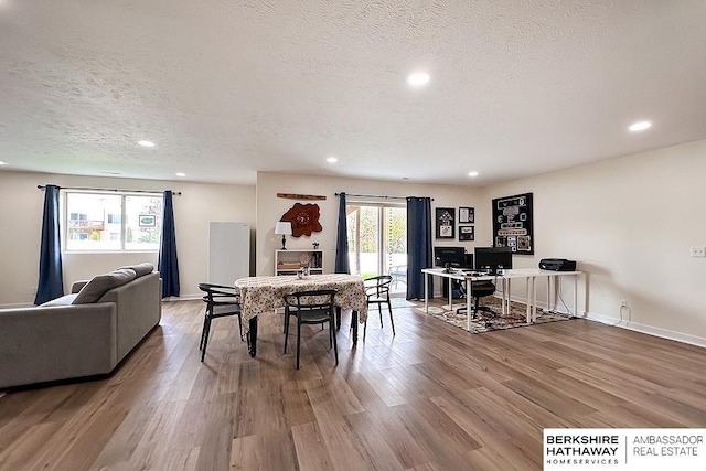 dining room featuring baseboards, recessed lighting, a textured ceiling, and wood finished floors