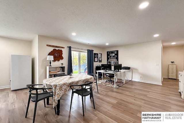 dining space featuring recessed lighting, baseboards, light wood finished floors, and a textured ceiling