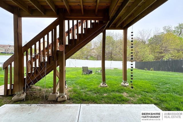 view of yard featuring stairs and a fenced backyard