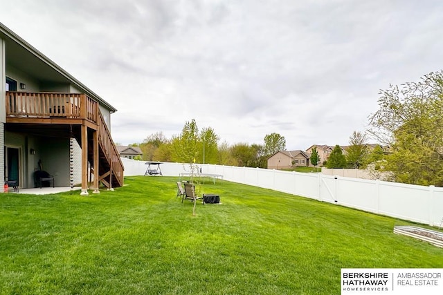 view of yard featuring a fenced backyard, stairs, and a wooden deck