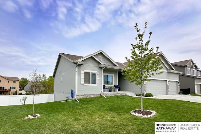 view of front of property with fence, concrete driveway, a garage, and a front yard