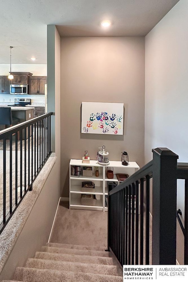 staircase featuring recessed lighting, carpet flooring, and baseboards