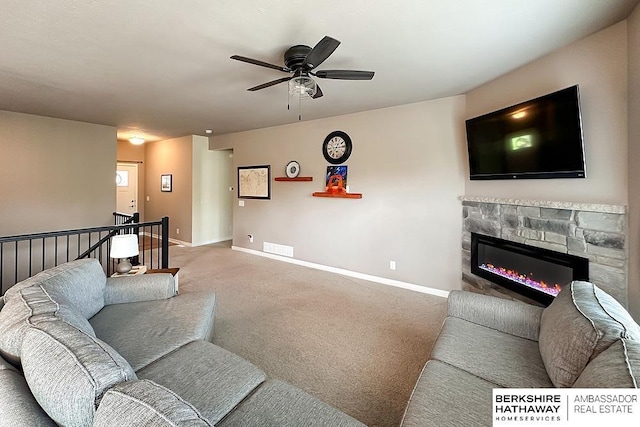 living area featuring visible vents, a fireplace, baseboards, a ceiling fan, and carpet