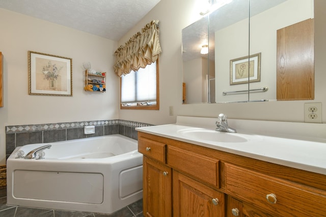 full bathroom with vanity, tile patterned flooring, a textured ceiling, and a bath