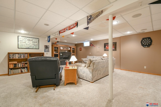 living room with baseboards, carpet flooring, and a paneled ceiling