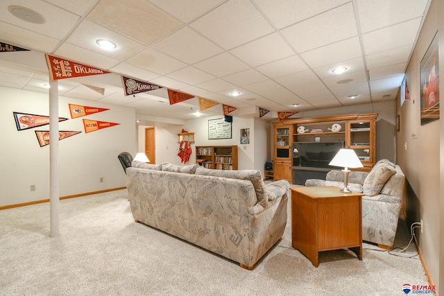 carpeted living area featuring recessed lighting, baseboards, and a drop ceiling