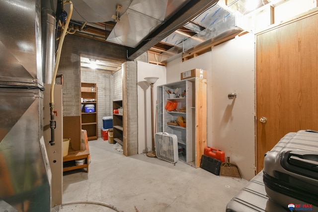 unfinished below grade area with brick wall