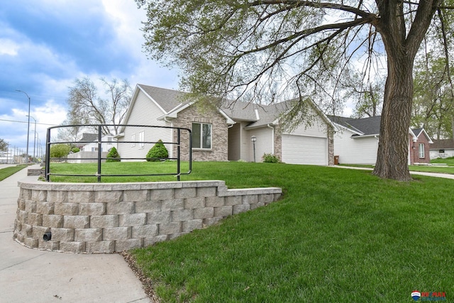 view of front of house with brick siding, a front lawn, and a garage