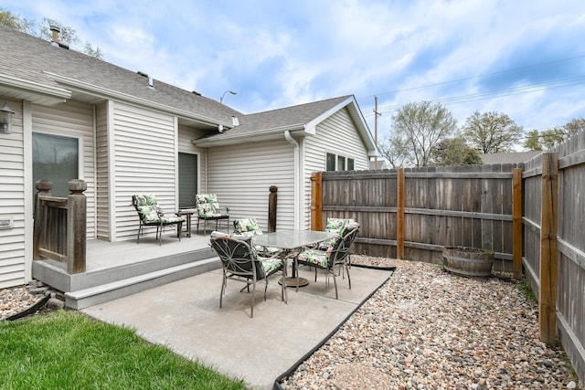 view of patio with a fenced backyard and outdoor dining area