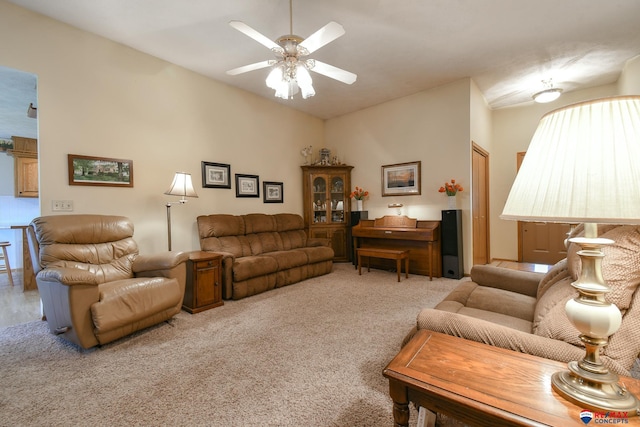 carpeted living room featuring vaulted ceiling and a ceiling fan