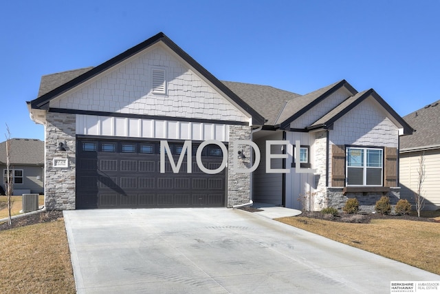 craftsman-style house with a garage, concrete driveway, and stone siding