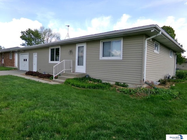 ranch-style house with an attached garage, driveway, and a front yard