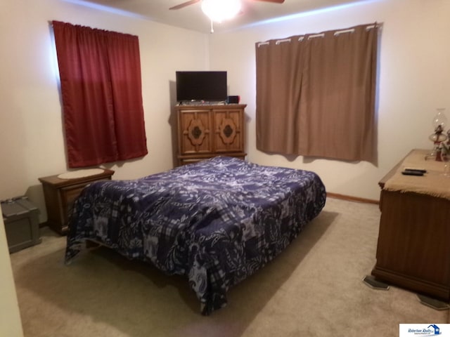 bedroom featuring light colored carpet and ceiling fan