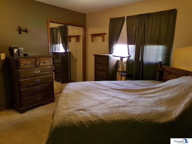 bedroom featuring light colored carpet and a closet