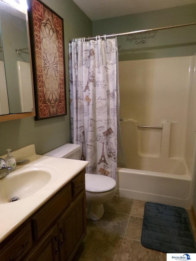 bathroom with vanity, shower / bath combo with shower curtain, and toilet