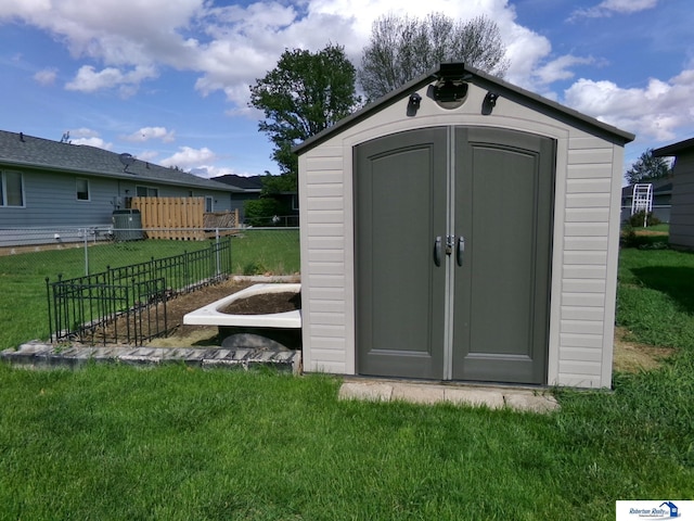view of shed with fence