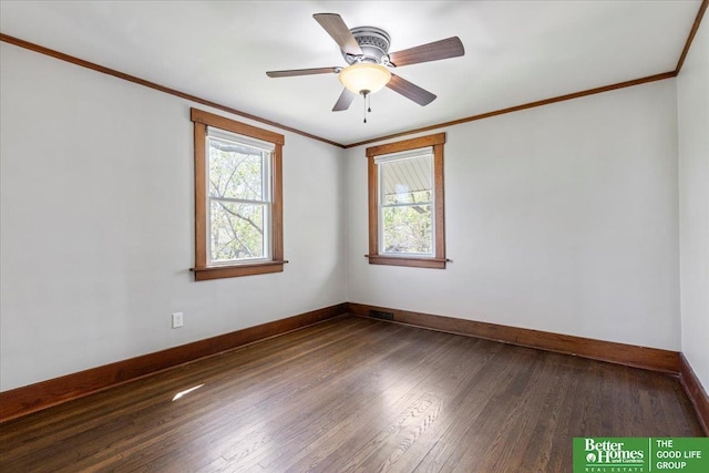 empty room with crown molding, baseboards, and a wealth of natural light