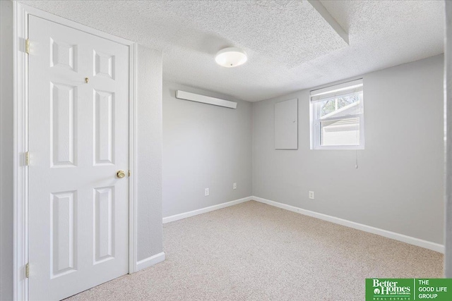 interior space with baseboards, carpet, and a textured ceiling