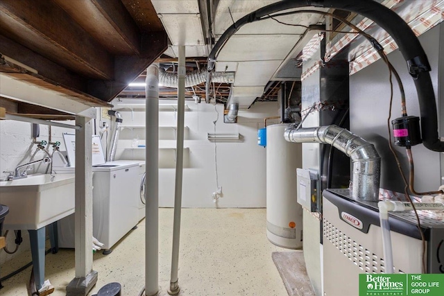unfinished below grade area with a sink, water heater, and washing machine and clothes dryer