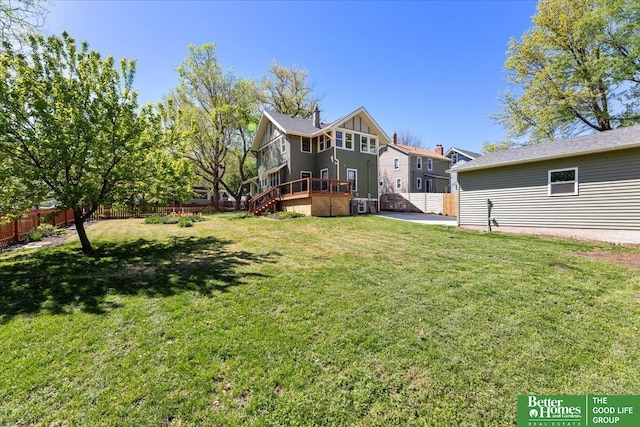 view of yard with stairs and a fenced backyard