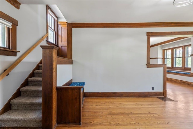 stairway with baseboards and wood finished floors