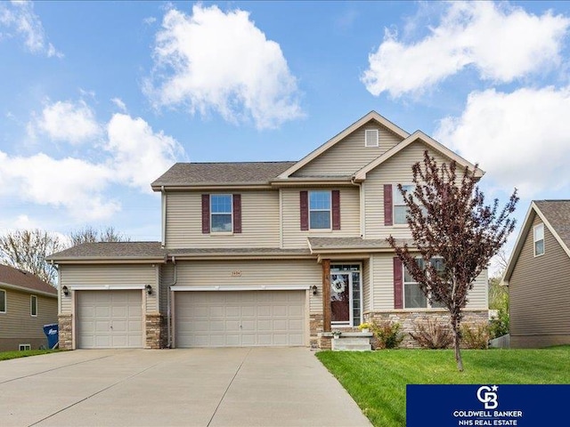 craftsman house featuring concrete driveway, an attached garage, stone siding, and a front lawn