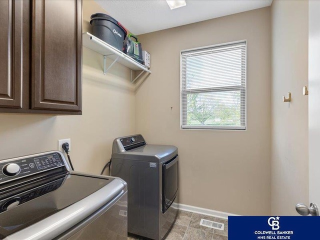 clothes washing area with baseboards, cabinet space, independent washer and dryer, and visible vents