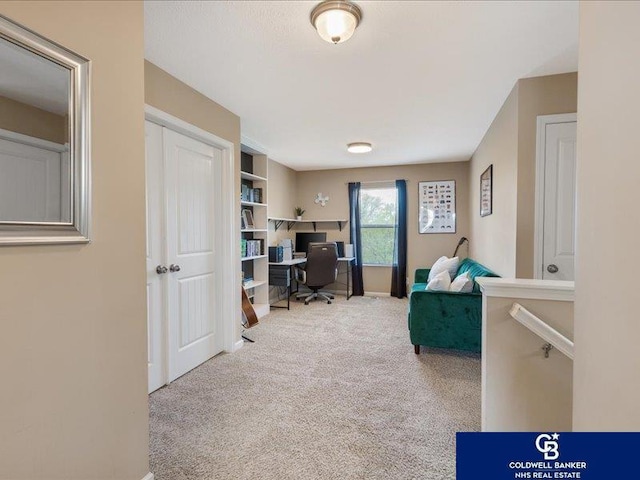 carpeted office space featuring baseboards