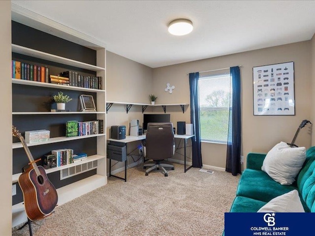 carpeted office space featuring baseboards