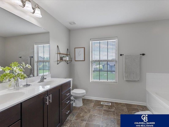 full bath featuring visible vents, a sink, baseboards, and double vanity