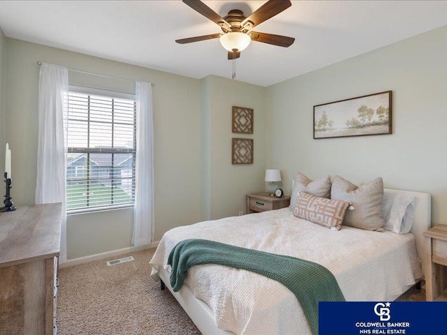 carpeted bedroom with baseboards, visible vents, and ceiling fan