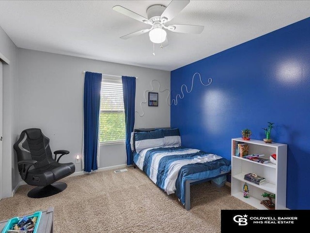 bedroom with baseboards, ceiling fan, carpet flooring, and visible vents